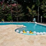 Custom Stone Pool Deck installed in Raleigh backyard by Bellus Terra