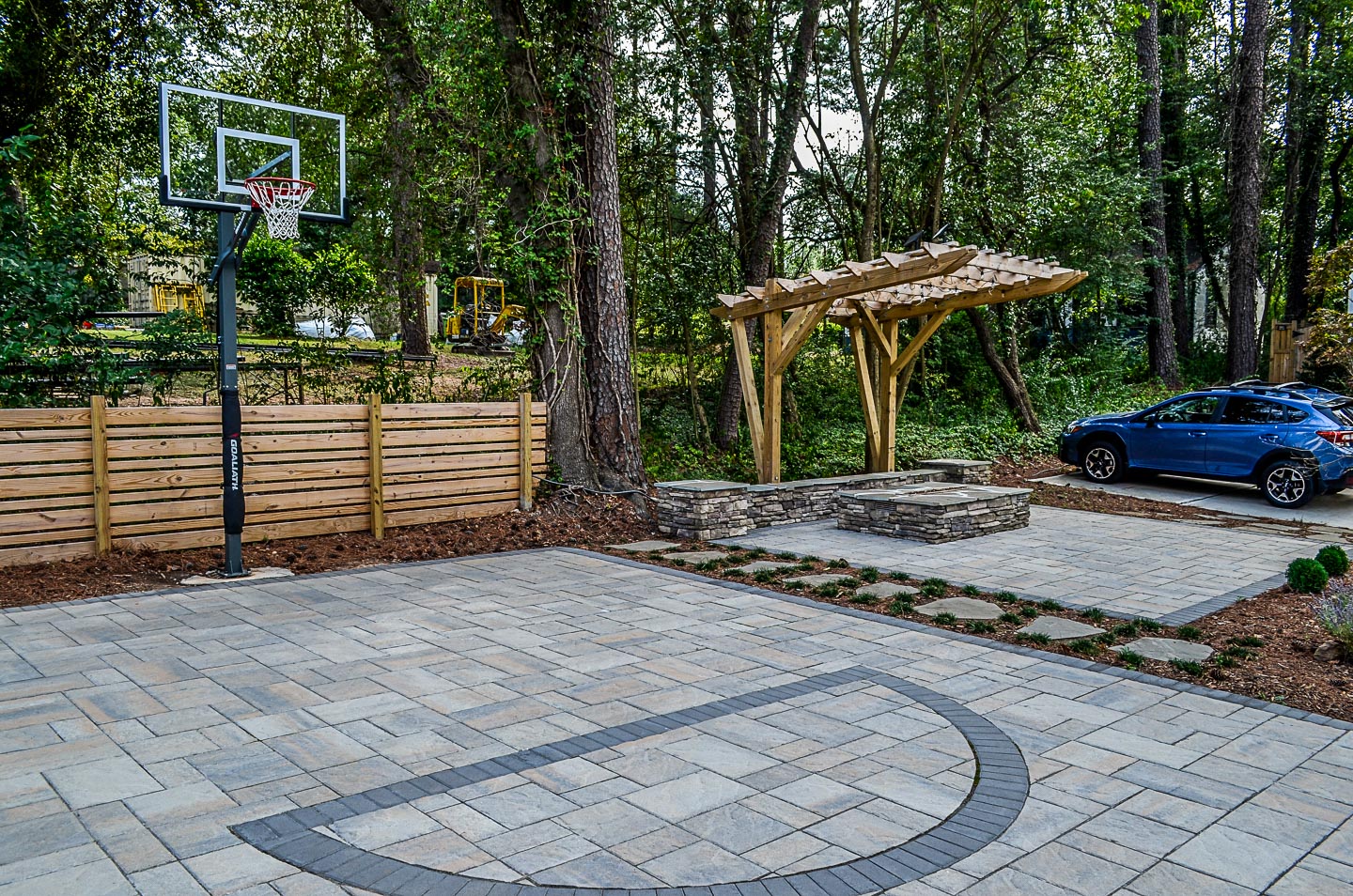 Raleigh outdoor living patio fire pit and basketball court